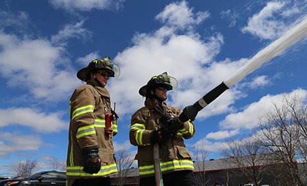 two firefighters training with hose